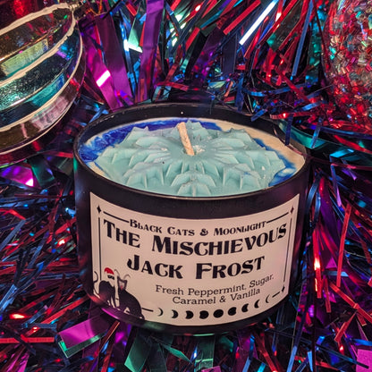 Candle labeled 'The Mischievous Jack Frost' surrounded by festive tinsel.